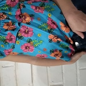A blue top with all different flowers